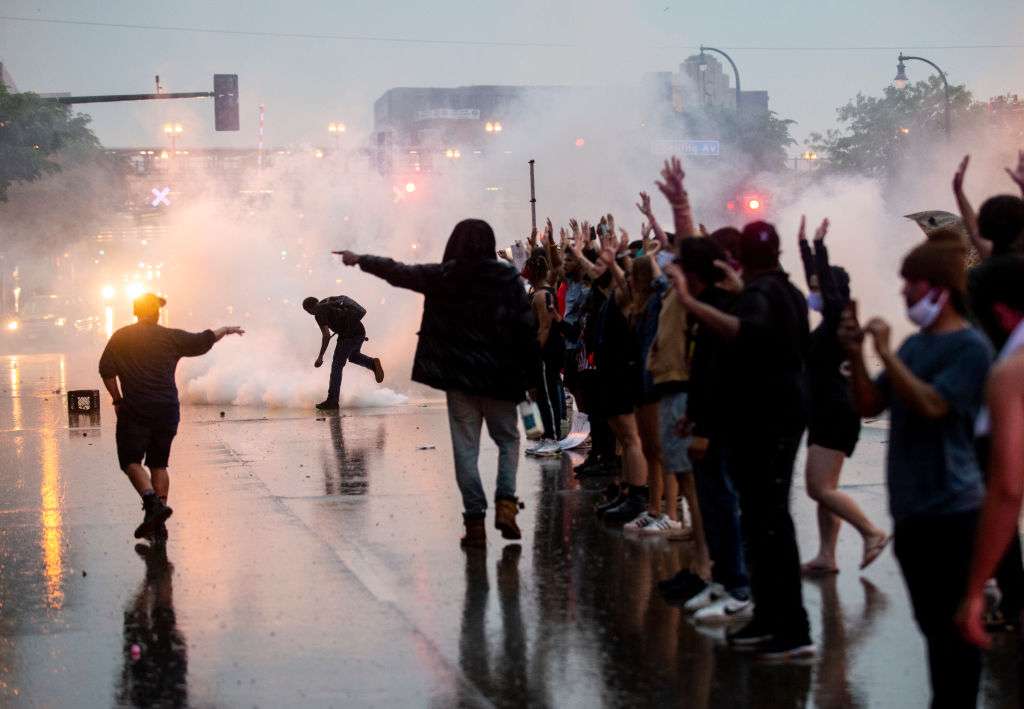 MINNEAPOLIS, MN - MAY 26: Tear gas is fired as protesters clash with police while demonstrating against the death of George Floyd outside the 3rd Precinct Police Precinct on May 26, 2020 in Minneapolis, Minnesota. Four Minneapolis police officers have been fired after a video taken by a bystander was posted on social media showing Floyd's neck being pinned to the ground by an officer as he repeatedly said, "I can’t breathe". Floyd was later pronounced dead while in police custody after being transported to Hennepin County Medical Center. (Photo by Stephen Maturen/Getty Images)